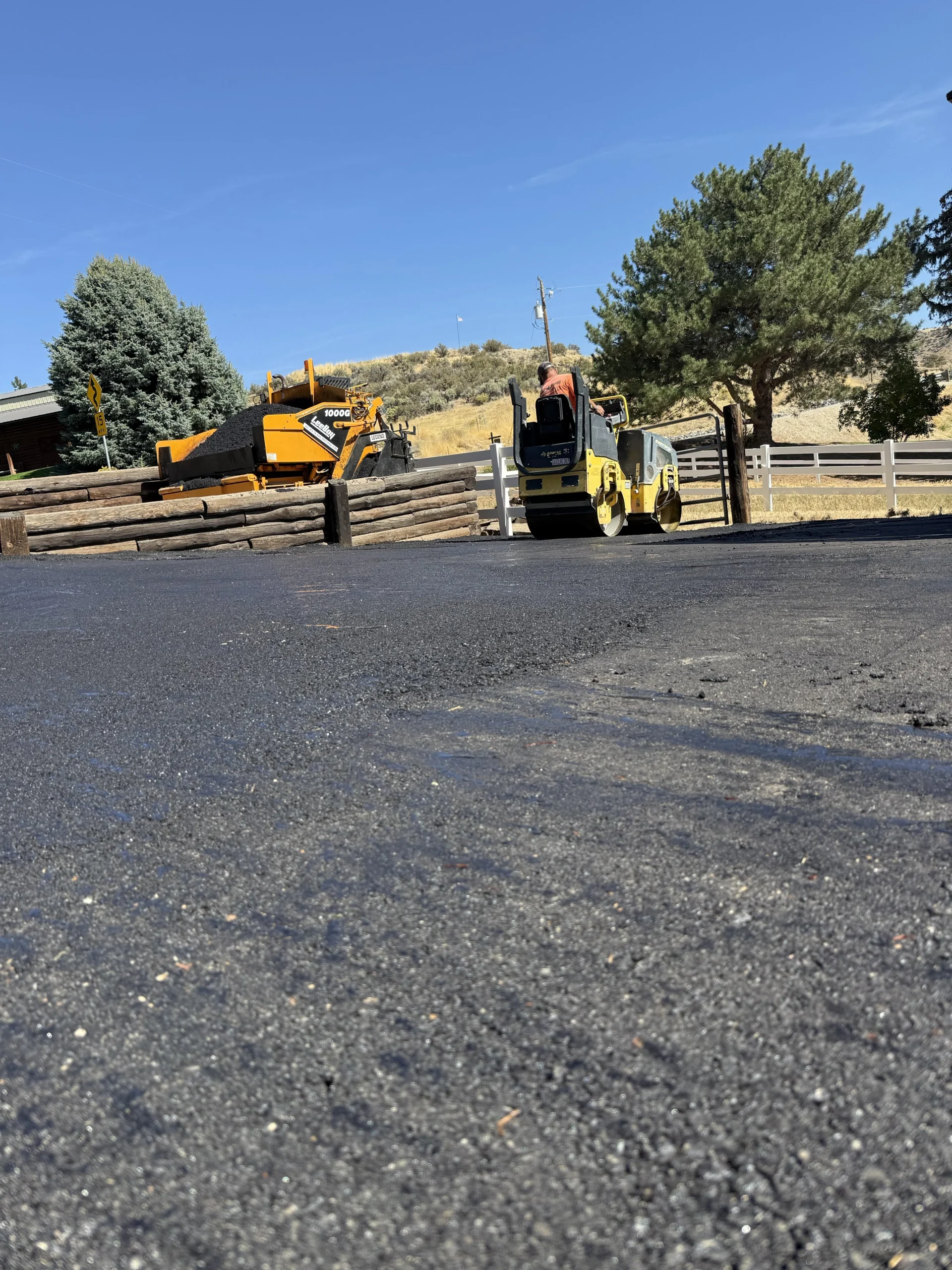 Sealcoating on a freshly paved surface with equipment on site