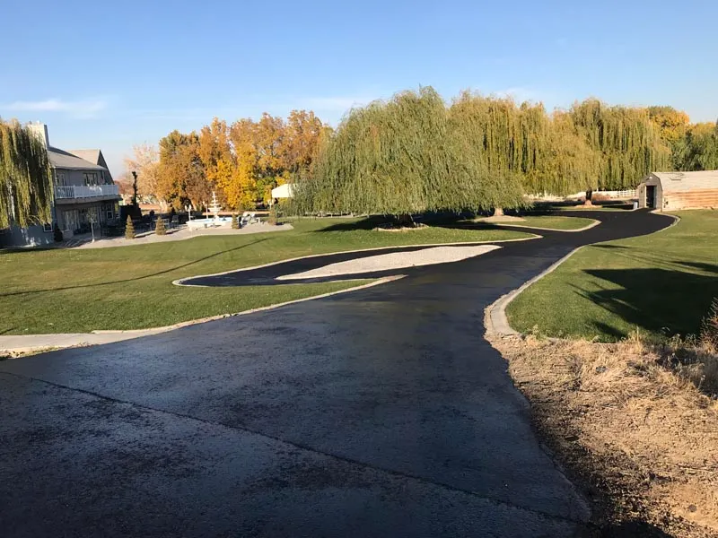 Sealcoating applied on a long curved driveway in Boise, Idaho