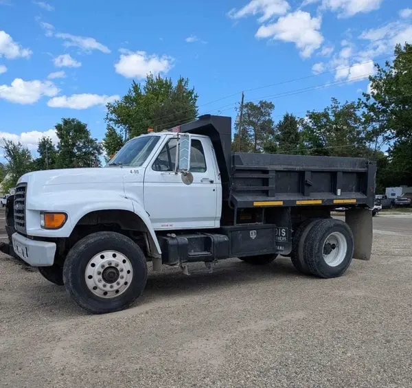 Heavy-duty Ford dump truck prepared for rock hauling services and aggregate delivery.