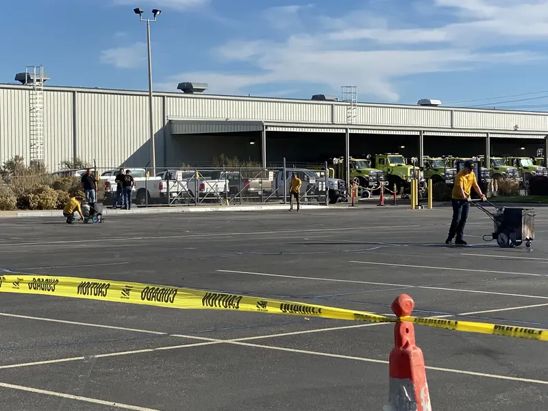Worker Using Jackhammer for Asphalt Parking Lot Repair