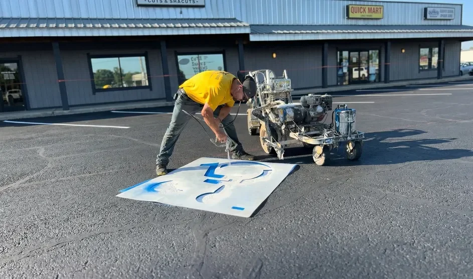 Superior Striping Technician Painting ADA Handicap Symbol on Sealcoated Parking Lot in Boise