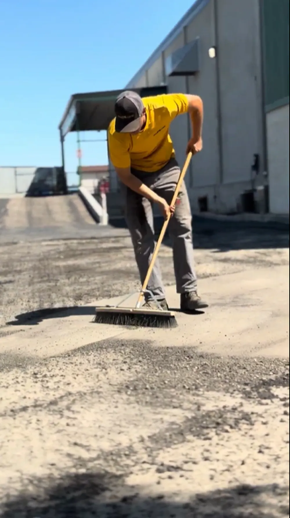 Superior Striping Crew Member Sweeping and Preparing Gravel Subbase Before New Asphalt Installation in Boise, Idaho