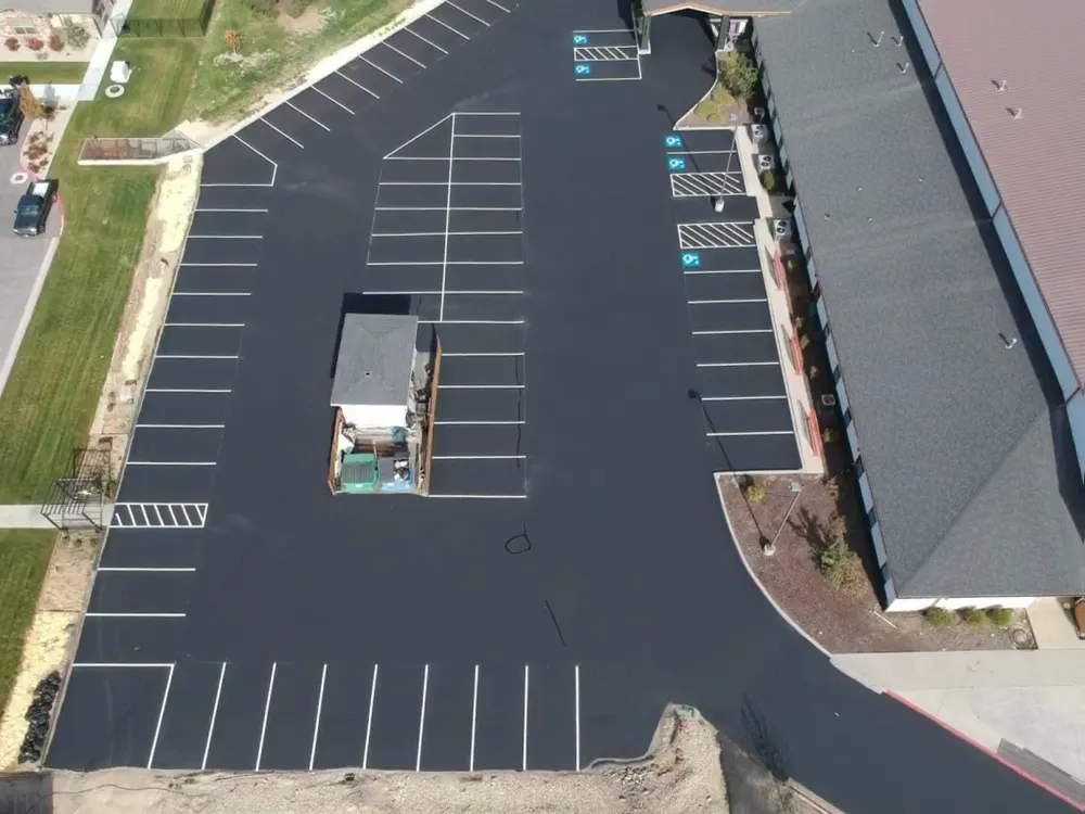 Aerial view of freshly sealcoated parking lot with new line striping by Superior Striping in Idaho