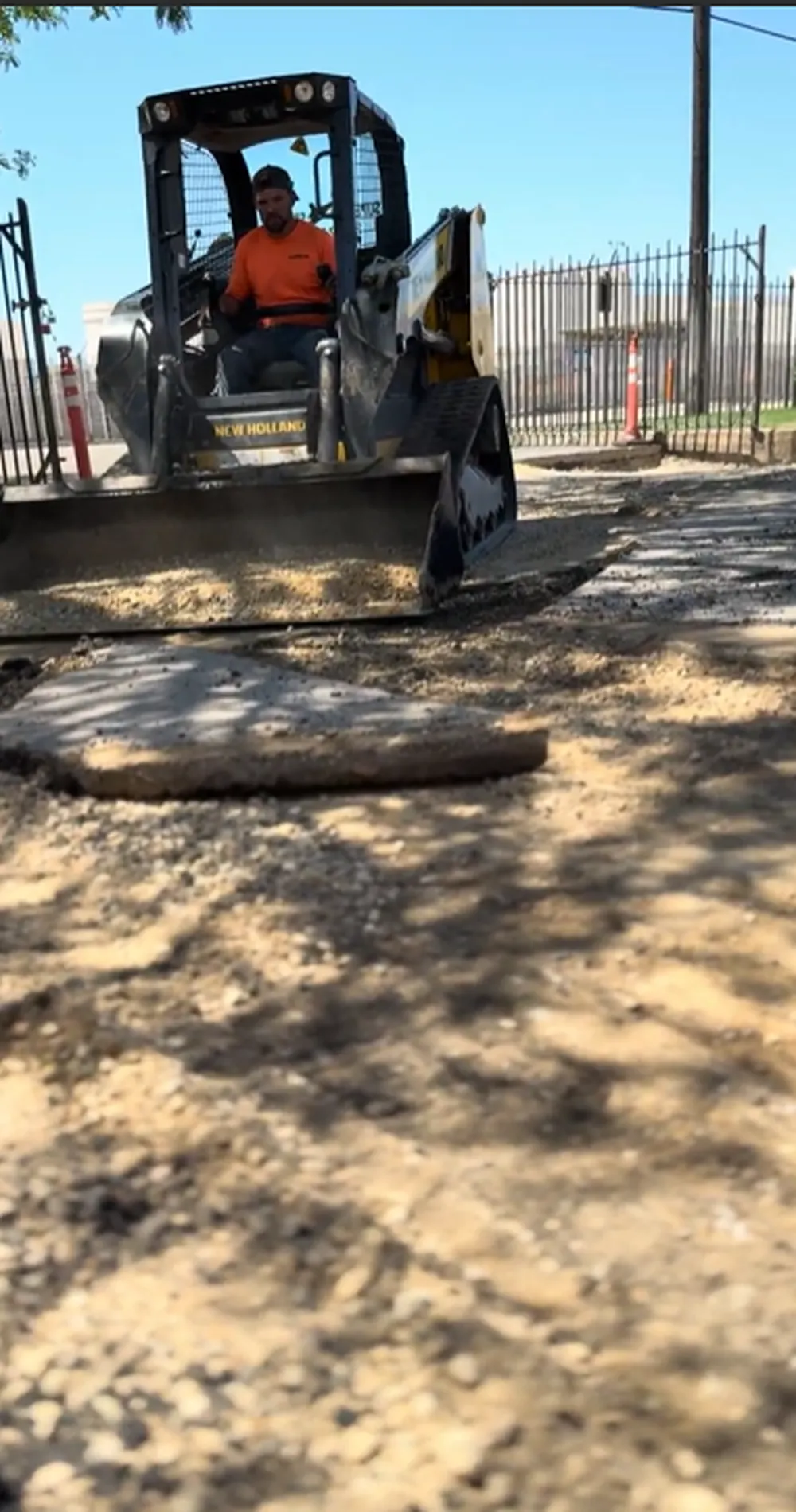 New Holland Skid Steer Grading and Clearing Gravel Base During Parking Lot Tear Out in Boise, Idaho