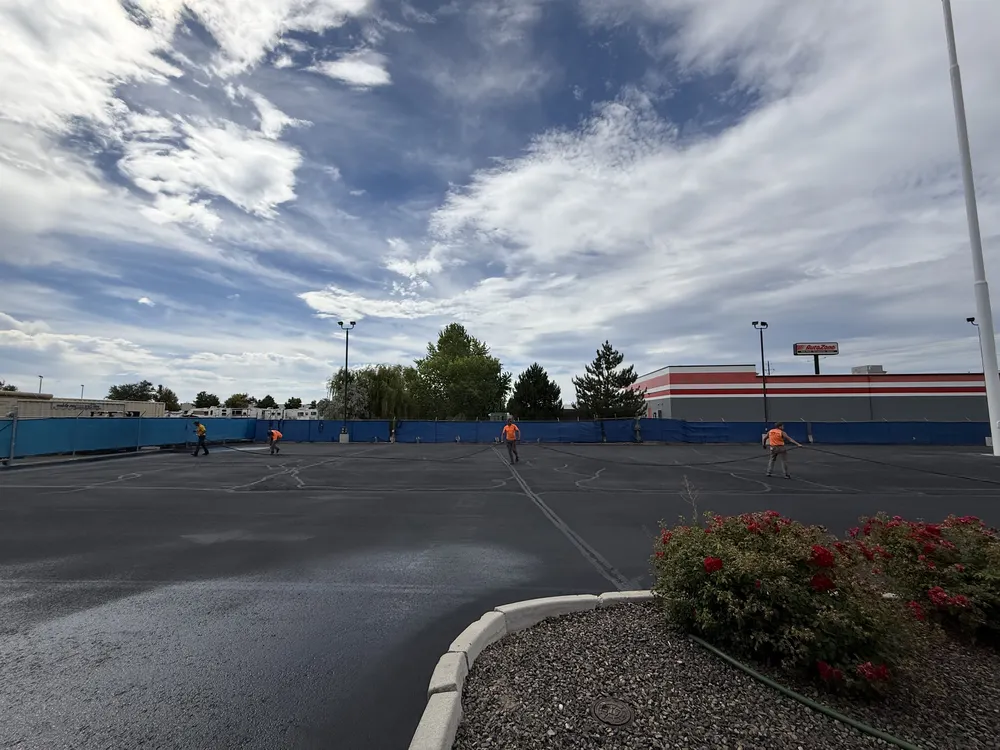 Superior Striping Crew Sealcoating Large Commercial Parking Lot at AutoZone in Caldwell, Idaho