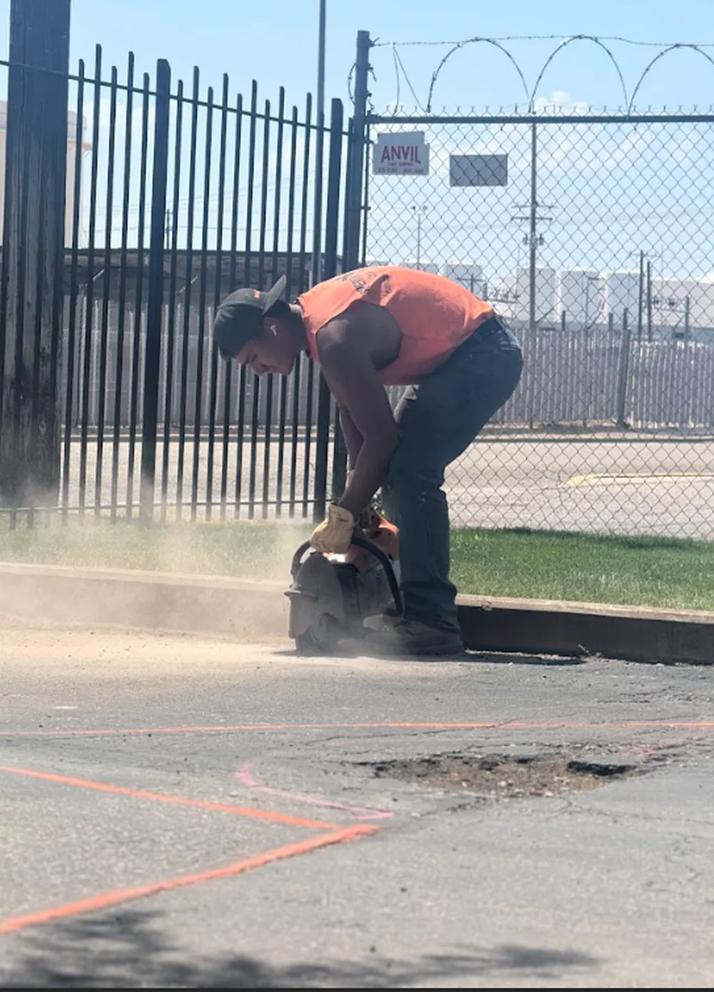 Superior Striping Crew Member Cutting Asphalt with Hand Saw in Boise, Idaho