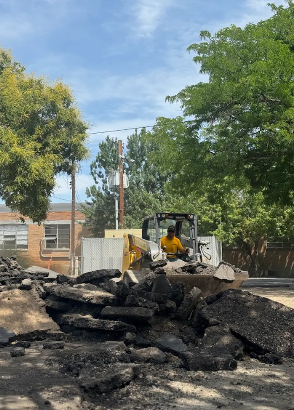 Superior Striping Skid Steer Operator Removing Broken Asphalt in Boise, Idaho