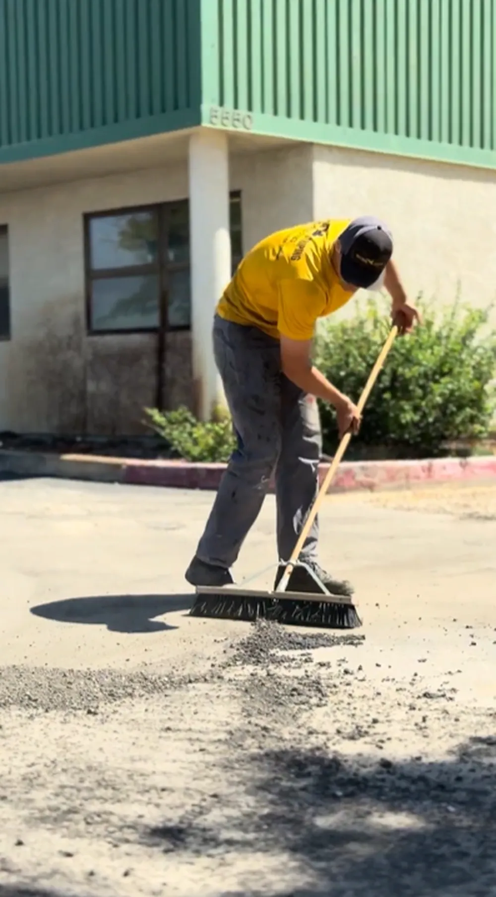 Superior Striping Worker Sweeping and Cleaning Parking Lot Surface Before New Asphalt Installation in Boise, Idaho
