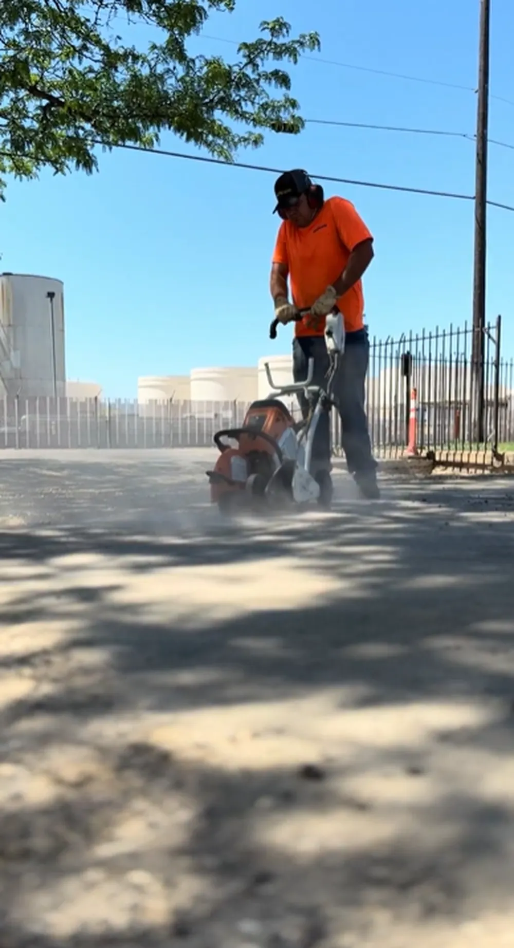 Superior Striping Worker Using Walk-Behind Saw to Cut Asphalt Edge During Parking Lot Tear Out in Boise, Idaho