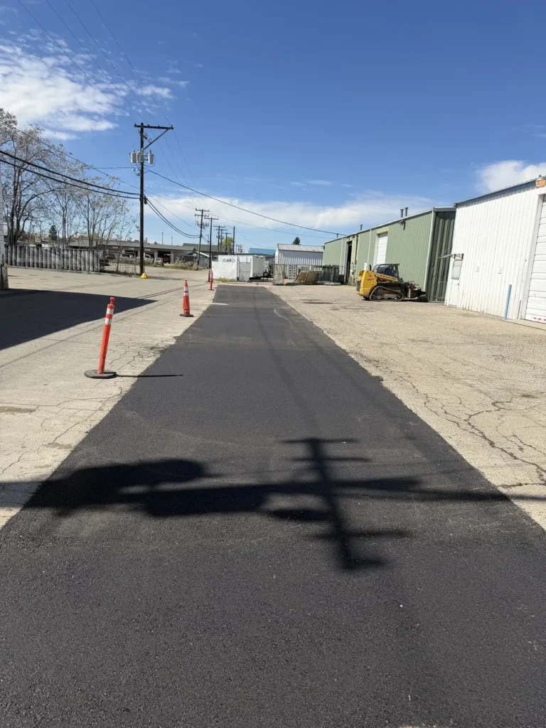 Professional asphalt patching and surface repair on a commercial access road in Boise, Idaho, performed by Superior Striping.